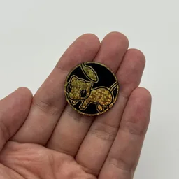 In hand, from Pokémon Coin Fan, full size